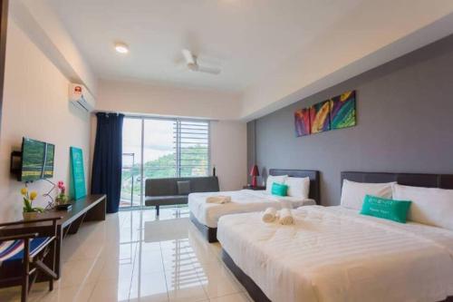 a hotel room with two beds and a window at Aeropod [5B]/Near Airport / 2 Queen Bed/ Netflix/Free Parking in Kota Kinabalu