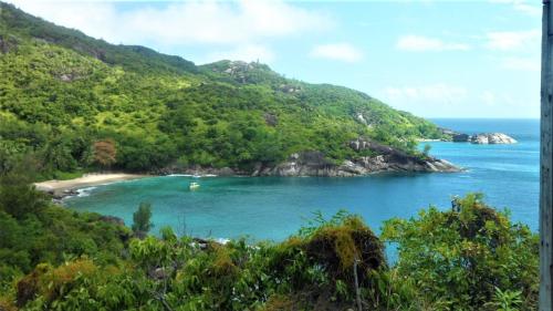 a view of a small island in the ocean at Seychelles Yellow Petals in Anse Boileau