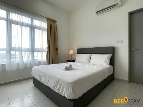 a bedroom with a bed with a stuffed animal on it at Mesa Hill Nilai by Beestay Management in Nilai