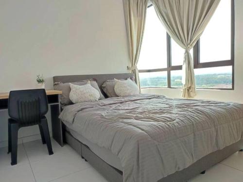 a bedroom with a bed and a desk and a window at Cozy Condo at Melaka Top Hill, 7-9pax in Ayer Keroh