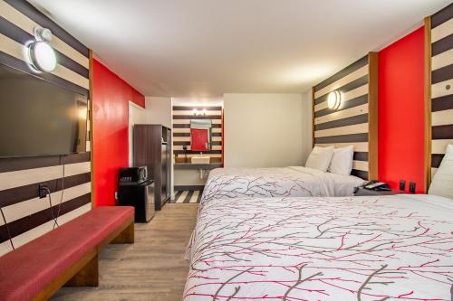 a hotel room with two beds and a tv at The Asheville Inn in Asheville