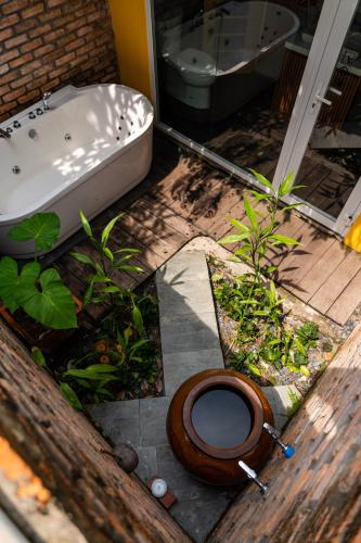 a bathroom with a toilet and a bath tub at Binh Minh Eco Lodge in Can Tho