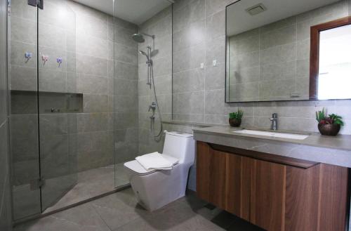 a bathroom with a toilet and a sink and a shower at K Residence & Apartment in Phnom Penh