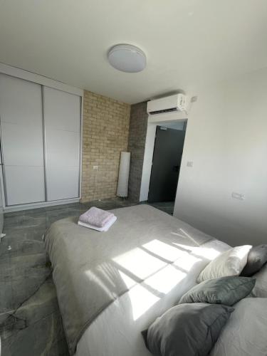 a bedroom with a large bed in a building at SEA& SUN in H̱adera