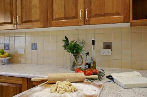 a kitchen counter with a cutting board with dough on it at Hilldo in Kurrajong