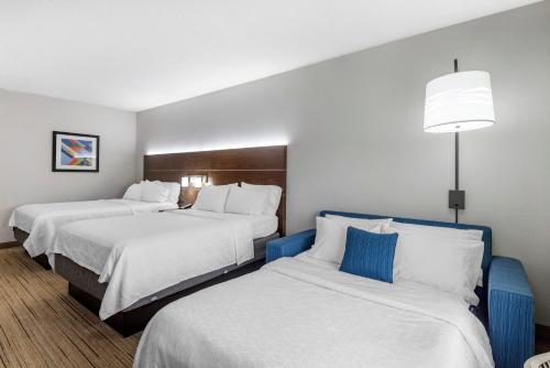 a hotel room with two beds and a lamp at Holiday Inn Express Charlotte West - Gastonia by IHG in Gastonia