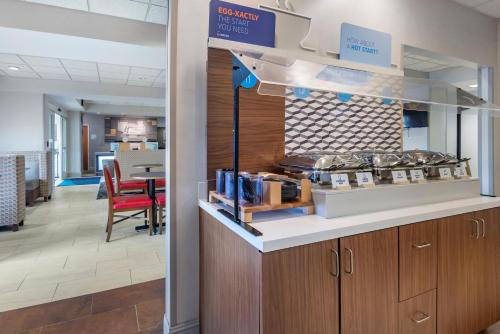 a restaurant with a counter with food on it at Holiday Inn Express Charlotte West - Gastonia by IHG in Gastonia