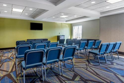a conference room with blue chairs and a screen at Holiday Inn Express Charlotte West - Gastonia by IHG in Gastonia
