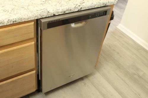 a dishwasher in a kitchen with a granite counter top at Cheerful 2-Bedroom, 2 bath with private parking in Fayetteville