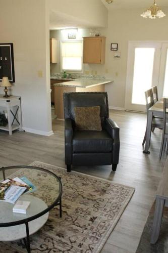 a living room with a chair and a table at Cheerful 2-Bedroom, 2 bath with private parking in Fayetteville