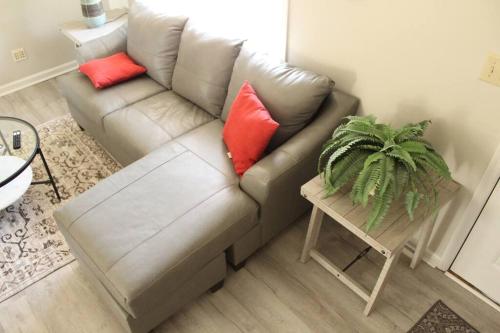 a living room with a couch with two red pillows at Cheerful 2-Bedroom, 2 bath with private parking in Fayetteville