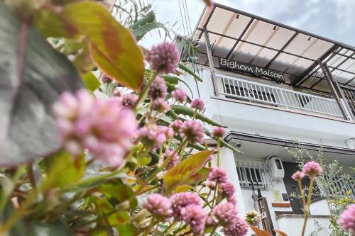 a bunch of pink flowers in front of a building at Bighem Maison in Izumi-Sano