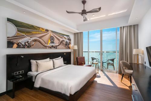 a bedroom with a large bed and a large window at Regal Réseau Hotel & Spa in Negombo