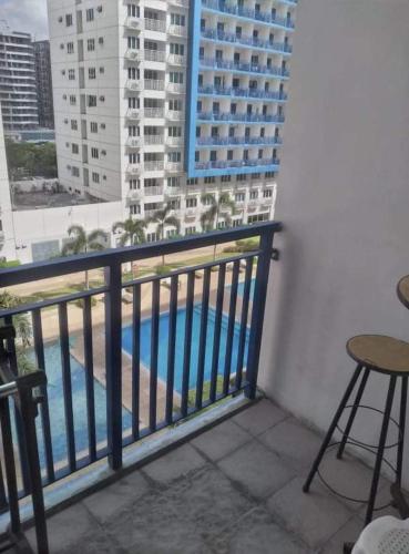 a balcony with a view of a swimming pool at LIAM's Staycation in Manila