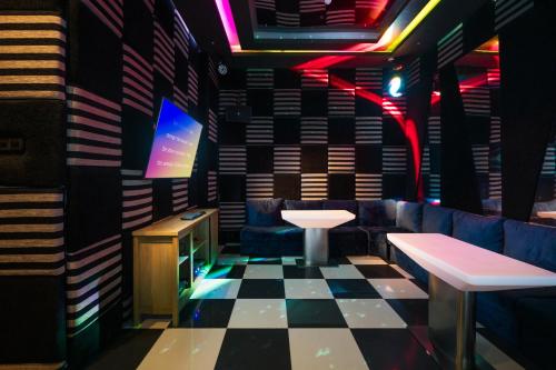 a bar with a checkered floor and a table and bench at Regal Réseau Hotel & Spa in Negombo