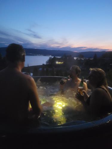 a group of people in a hot tub with drinks at Apartman Cassovia in Holčíkovce