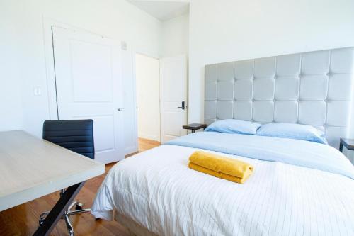 a bedroom with a bed with a yellow towel on it at 4BR 1,5BH Comfy Newly Renovated Apt in Boston