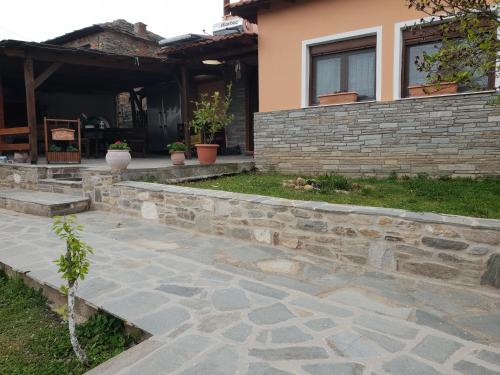 a stone walkway in front of a house at Mavridis House in Eleftheroúpolis