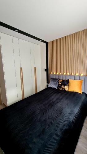 Posteľ alebo postele v izbe v ubytovaní Mazurski apartament