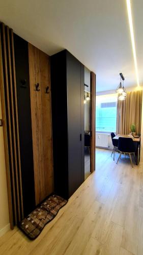 a room with a room with a door and a table at Mazurski apartament in Ostróda