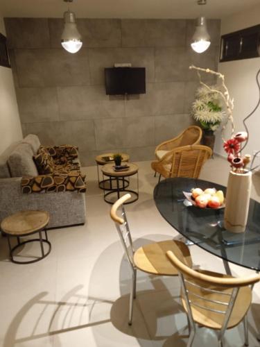 a living room with a glass table and chairs at Willa Sandal in Eilat