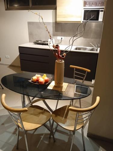a glass table with a bowl of fruit on it in a kitchen at Willa Sandal in Eilat