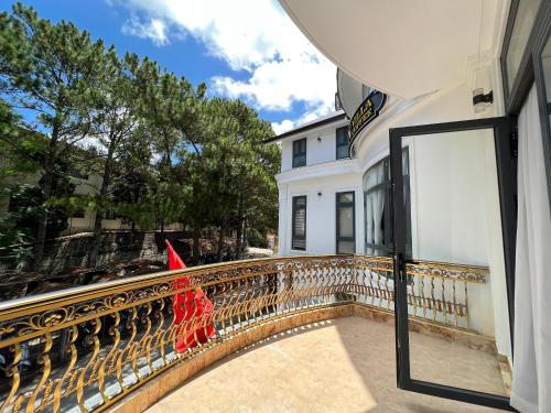 a balcony of a house with a flag on it at Win Villa Coffee in Da Lat