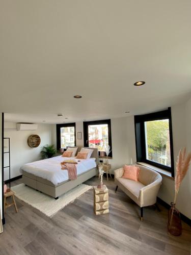 a bedroom with a large bed and a couch at Boutique Hotel LE•BAR in Zandvoort