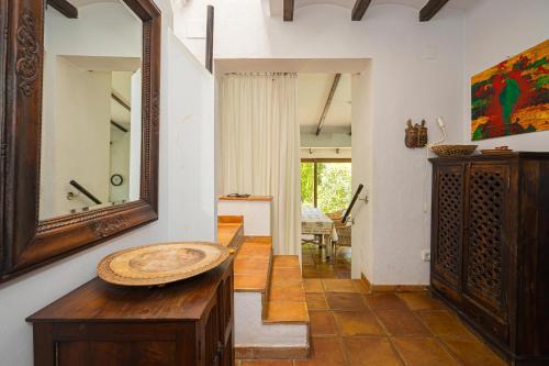 a living room with a mirror and a table at Casa Colina in Albir