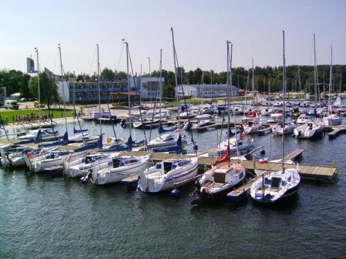 a bunch of boats docked in a harbor at Nowoczesny Apartament z widokiem na jezioro in Charzykowy