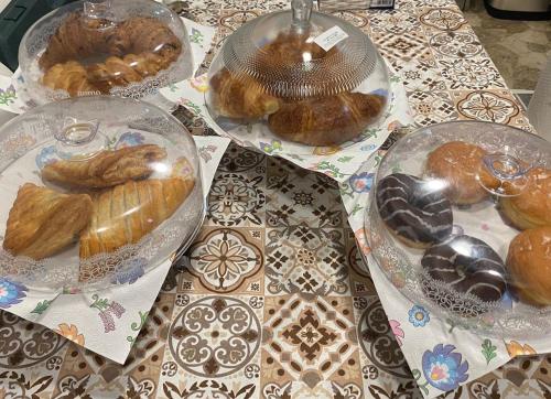 a table with several plates of pastries on it at "La Selvetta" bed and breakfast in Buguggiate