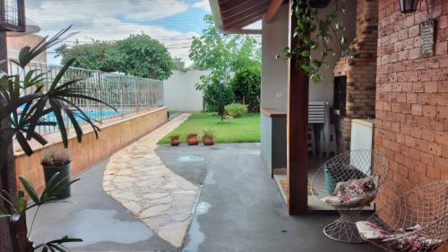 a courtyard of a house with a patio with plants at Pousada e Hotel Italian Garden House in Campo Grande