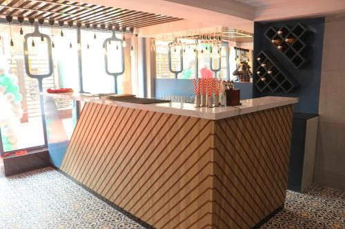 a restaurant with a counter with wine bottles at Hotel Grand Residency in Jamshedpur