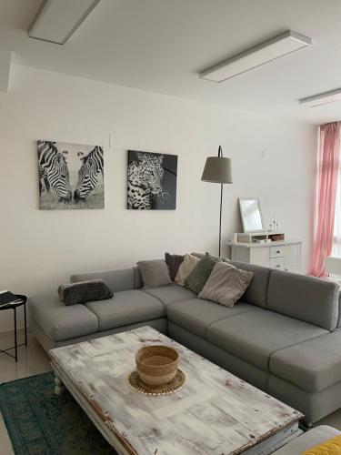 a living room with a couch and a table at Stadtsuite mit Sauna in Wiener Neustadt 135 m2 in Wiener Neustadt