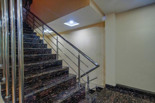 a stairway in a building with a railing at FabHotel Pishori in Indore