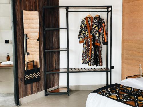 a room with a shelf with a robe on it at UMVA Muhazi in Muhazi
