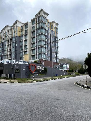 an empty street in front of a large building at Azzalea Homes 2 @ Taman Golden Hills Cameron Highlands in Cameron Highlands