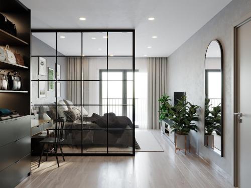 a bedroom with a bed and a desk in a room at LAGOM APARTMENT AND HOTEL in Da Nang