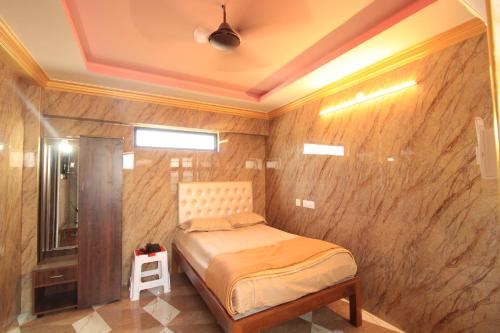 a bedroom with a bed and a wooden wall at French Breeze Residency in Puducherry