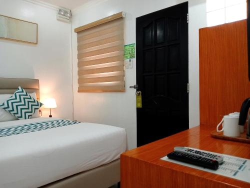 a bedroom with a bed and a desk with a keyboard at Grand Blue Beach Hotel in Boracay