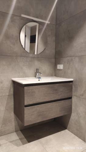 a bathroom with a sink and a mirror at Willa Sandal in Eilat