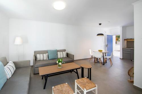 a living room with a couch and a table at Aliathon Aegean in Paphos City