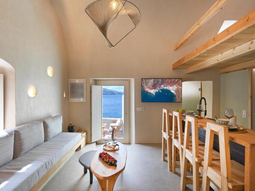a living room with a couch and a table at Secret Gem Suites in Oia