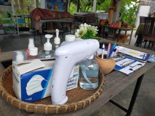 a white blow dryer sitting on a table at Metha Country View Homestay Singburi in Ban Kho Sai