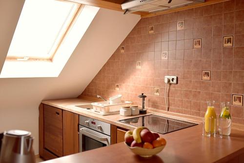 a kitchen with a sink and a bowl of fruit on a table at Nawiady 18A in Piecki