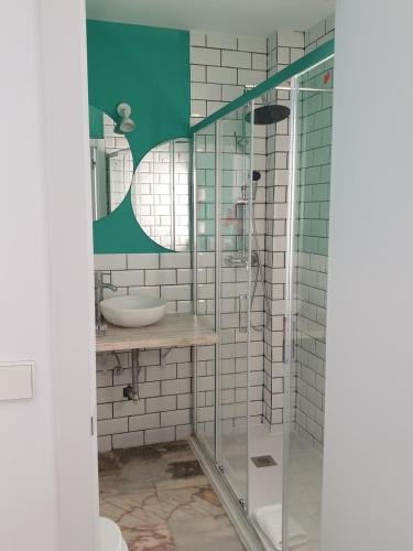 
a bathroom with a shower stall and a sink at Hotel y Apartamentos Doña Lola in Seville
