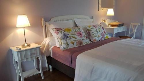a bedroom with a bed and two tables with lamps at Relais de navon in Saint-Joseph