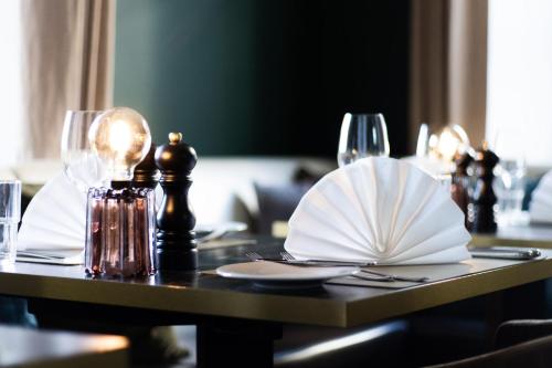 a table with plates and wine glasses on it at Seehotel Luitpold in Tegernsee