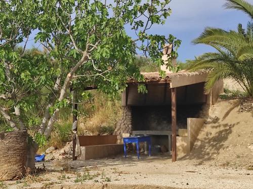 a building on the side of a dirt road at Casa Ramoncico. Finca el Campillo in Blanca