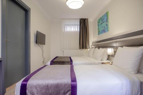 Ein Bett oder Betten in einem Zimmer der Unterkunft Taksim 11 Suites